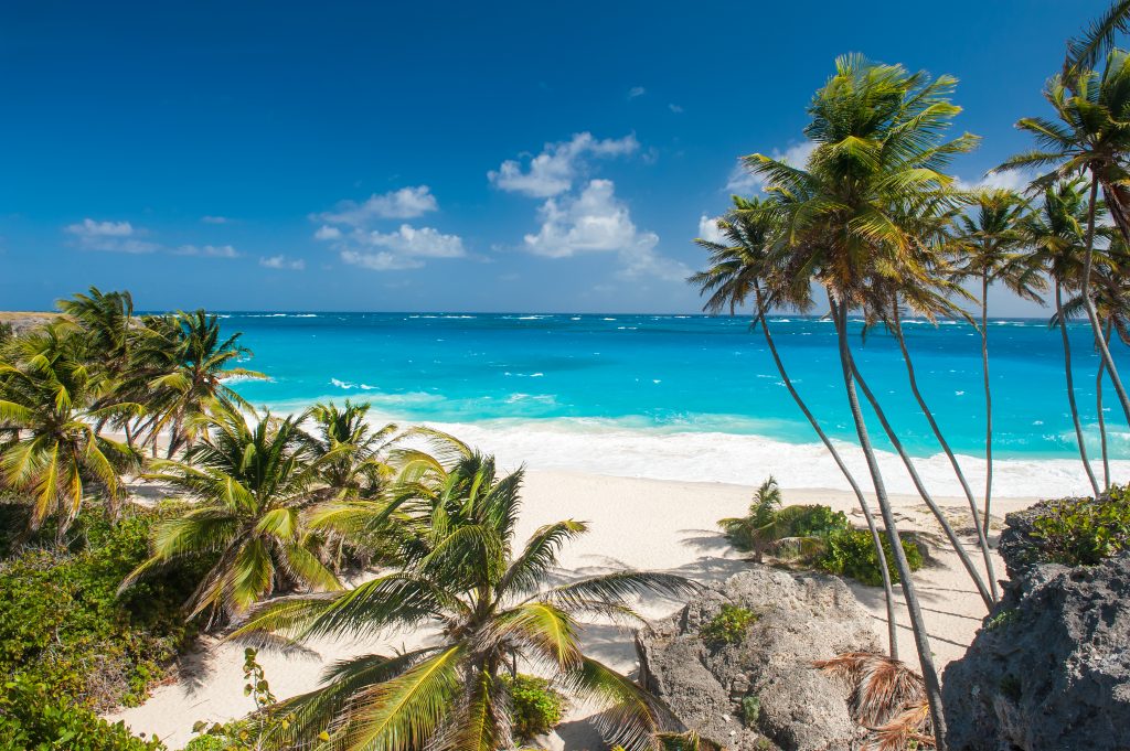 Bottom Bay is one of the most beautiful beaches on the Caribbean island of Barbados. It is a tropical paradise with palms hanging over turquoise sea. Best hidden gem beaches barbados