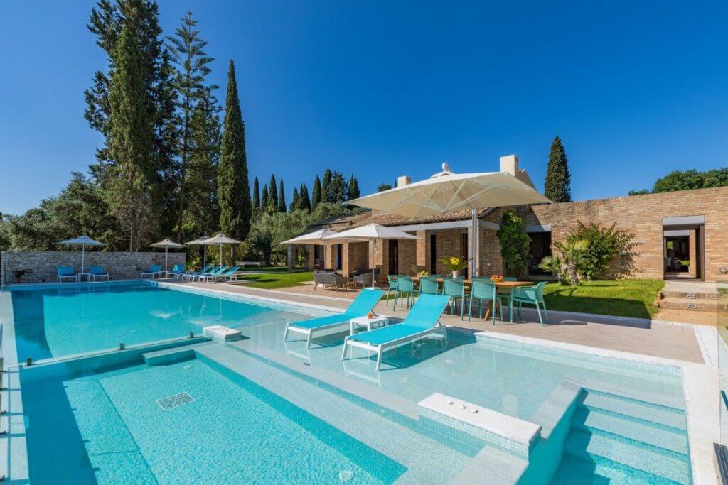 Villa Ionica in Corfu, part of our luxurious Greek island holidays feature, offering privacy and a sleek poolside setting.