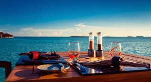 Table setting at tropical beach restaurant during summer sunset