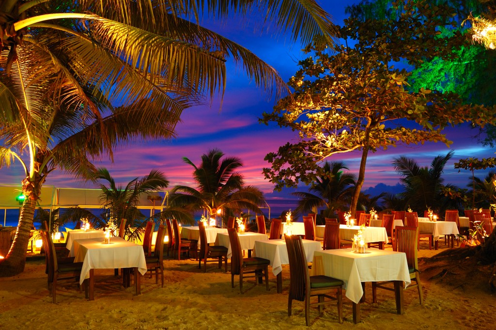 Outdoor restaurant at the beach during sunset. Dining British Virgin Islands