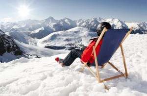 Women at mountains in winter lies on sun-lounger,France high mountains. Val D’Isere