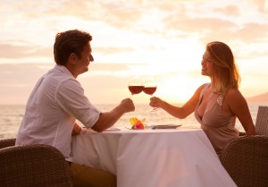 Couple sharing romantic sunset dinner on the beach. Eat on Tortola