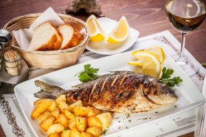 Dorado fish served on restaurant table. Foodie destinations Barbados