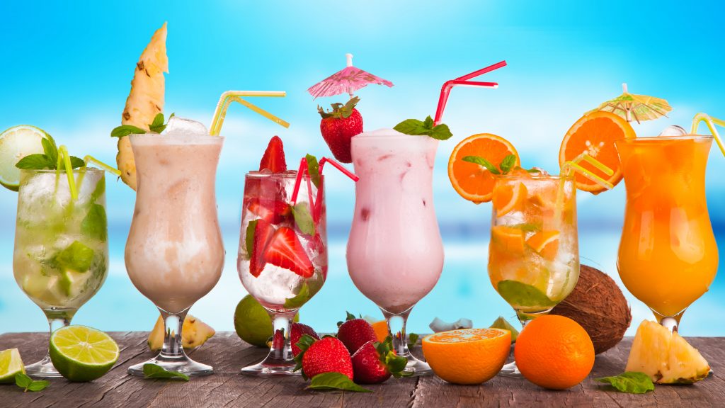 Summer drinks with blur beach on background. St Tropez Beach Bars