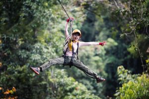 Woman Tourist Wearing Casual Clothing On Zip Line Or Canopy Experience. exploration antigua