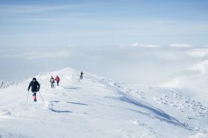 People walking in mountains in deep snow. Best things to do in Val d'Isere