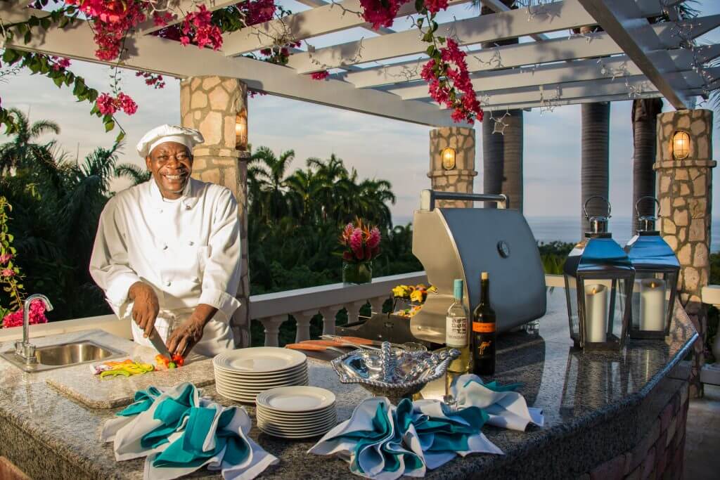 Cap Cana private chef preparing a personalized outdoor meal for villa guests in a luxury Caribbean villa