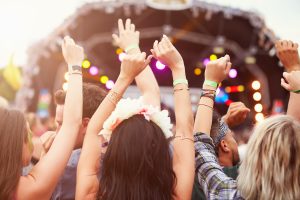 Audience with hands in the air at a music festival. Caribbean Music Festivals