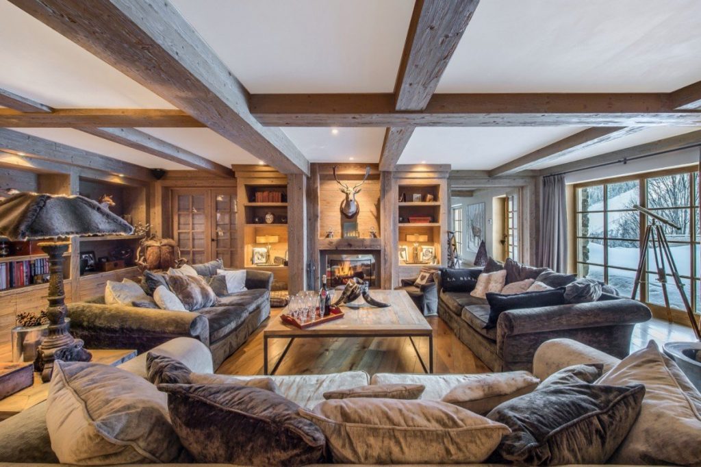 Cozy living room with a fireplase. Chalet d'Hadrien, Meribel. Experience Meribel