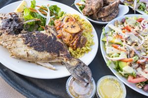A grilled Trigger fish served with rice and vegetables. Best restaurants in St Lucia