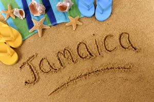 The word Jamaica written on a sandy beach. Jamaica weather in December