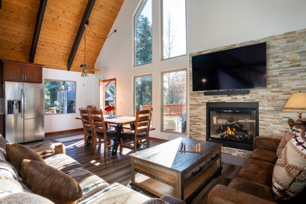 Cozy Cabin North Lake Tahoe living room with fireplace and vaulted wood ceiling