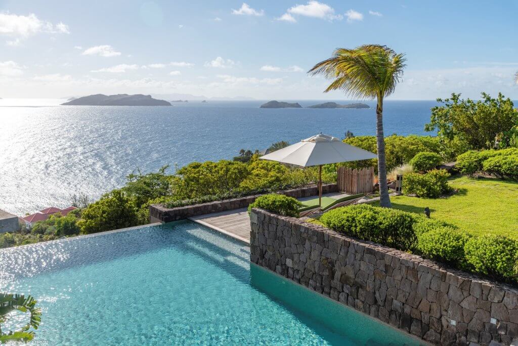 St Barts Vacation Rentals: Villa Tainos St Barts vacation rentals: Tainos infinity pool with ocean views, palm, gardens and shaded loungers