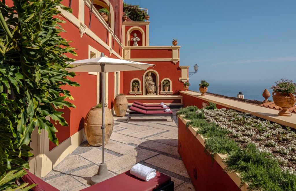 Historic Amalfi Coast palazzo floating above Positano with frescoes.