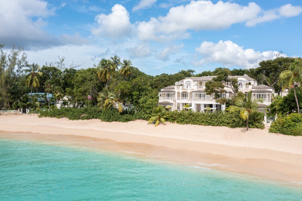 Beachfront estate with turquoise waters, private beach access, and luxury architecture at Villa Kiko in Barbados.