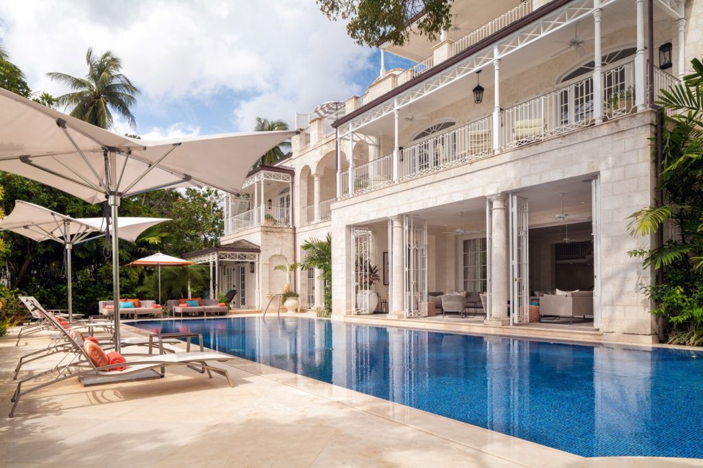 Spacious swimming pool and covered verandah at Villa Kiko, a luxury beachfront estate in Barbados with premium amenities.