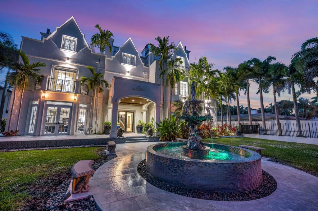 Grand waterfront villa in Fort Lauderdale at sunset, perfect for a South Florida luxury escape with privacy and elegance.