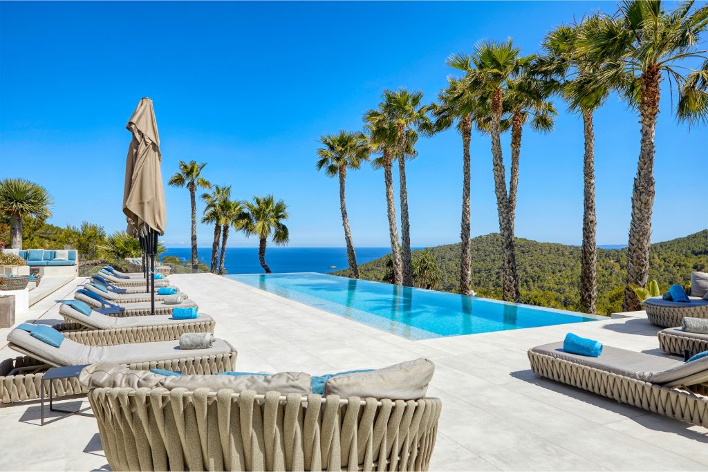 Villa de Sueños in Ibiza with sea views, palm trees, and an infinity pool, one of the top exclusive villas in Spain.