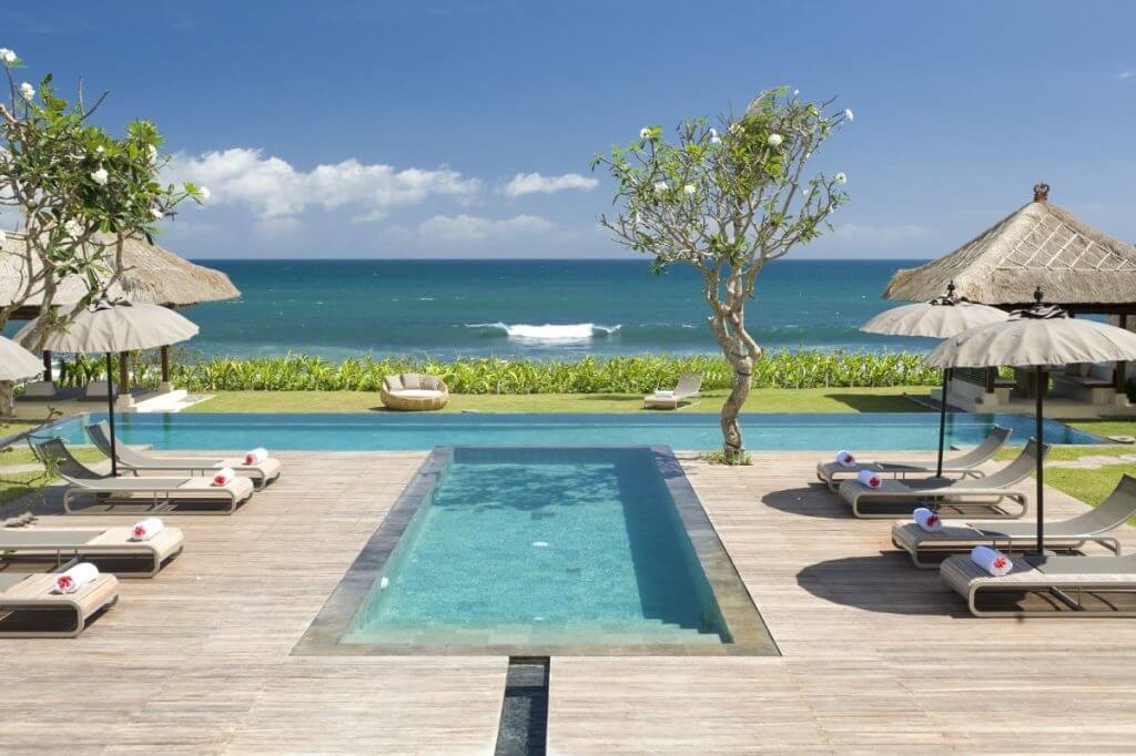Bali’s beachfront Villa Melissa with ocean views, pools, and tropical pavilions, part of Isle Blue’s villa collection.