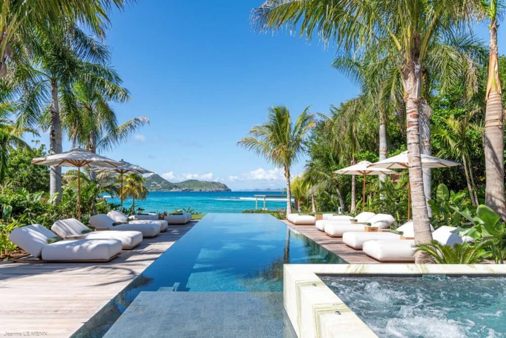 Villa Palm Beach with oceanfront loungers, infinity pool, and palm trees, perfect for the St Barts Island-Wide Countdown.