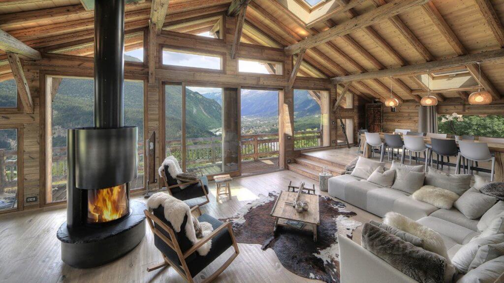 Chalet Norel living room with fireplace, rustic wood design, and panoramic mountain views in Chamonix.