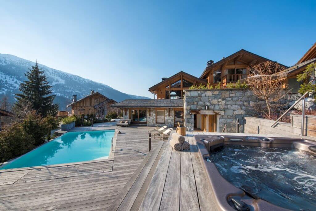 Chalet Mont Tremblant in Méribel with outdoor pool, hot tub, and panoramic French Alps ski mountain views.