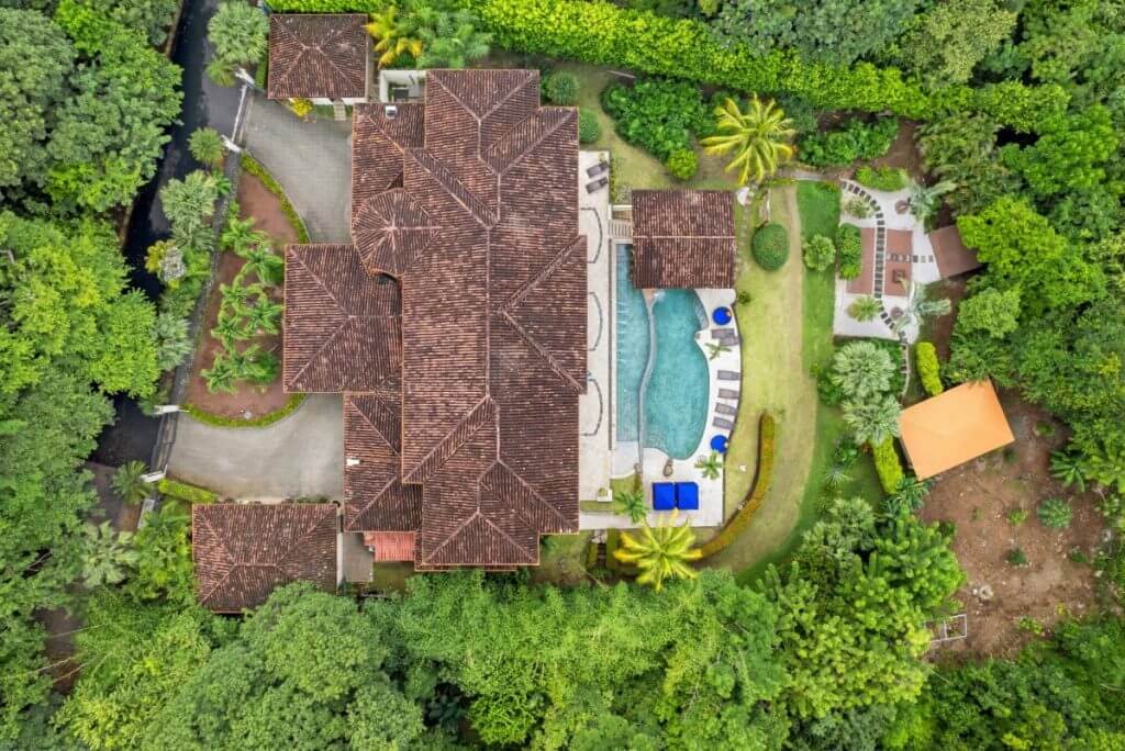 Aerial view of Villa Buena Onda, Costa Rica with private pool, gardens, and lush tropical forest surroundings.
