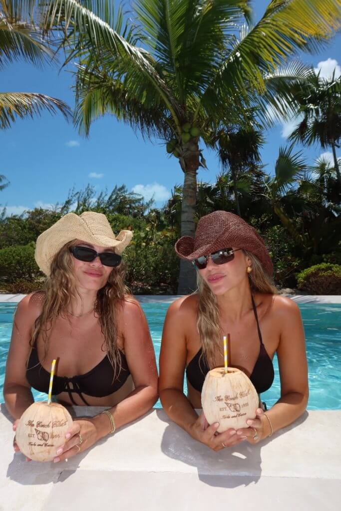 Jordan and her friend sip coconut drinks in the private pool at their Turks and Caicos bachelorette celebration