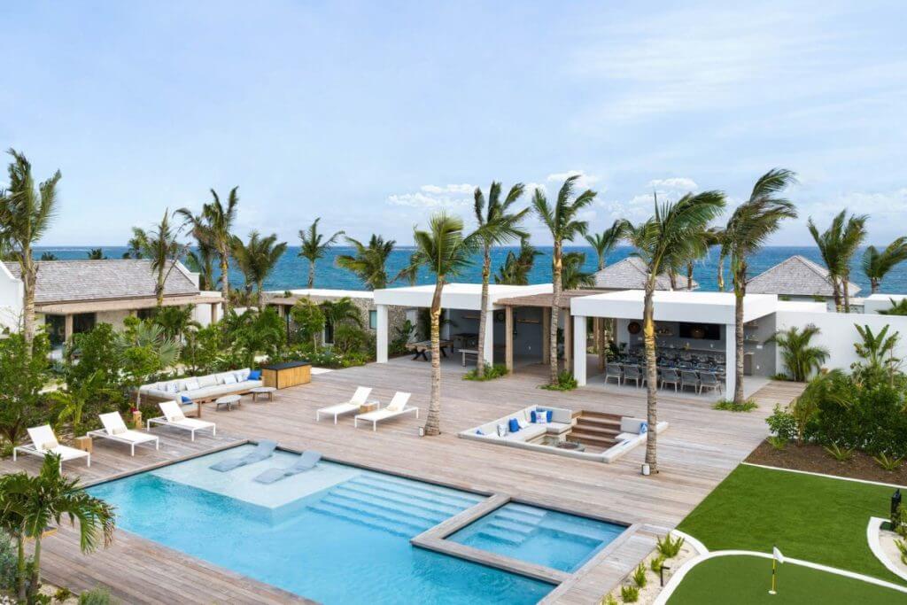 Ambergris Cay Dream Away villa with pool, sun loungers, outdoor bar, and ocean views showcasing luxury concierge services