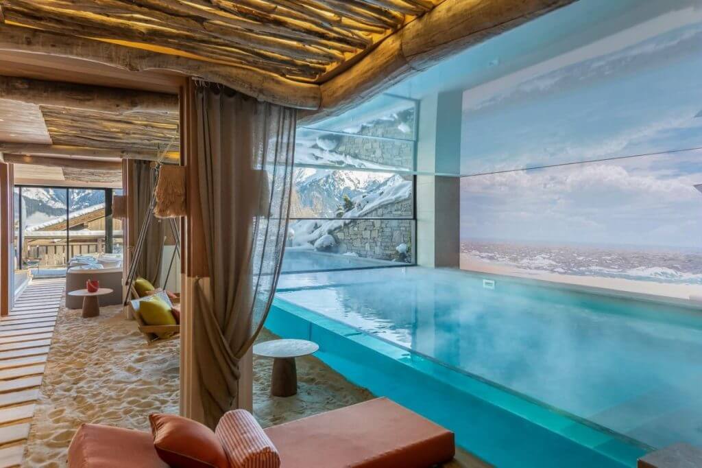 Chalet White Sand shows tailored experiences over standard luxury with a heated pool, indoor sand lounge, and mountain views.