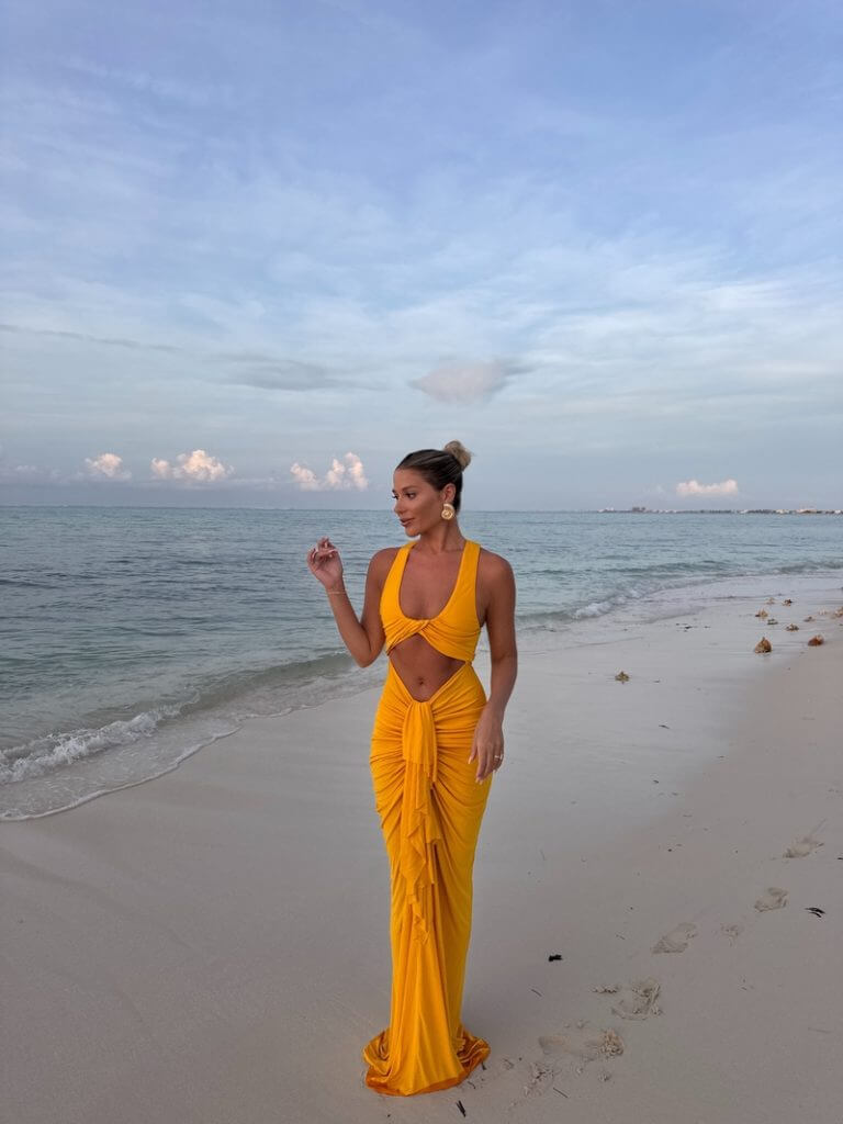 Jordan in yellow dress at golden hour during Turks and Caicos bachelorette