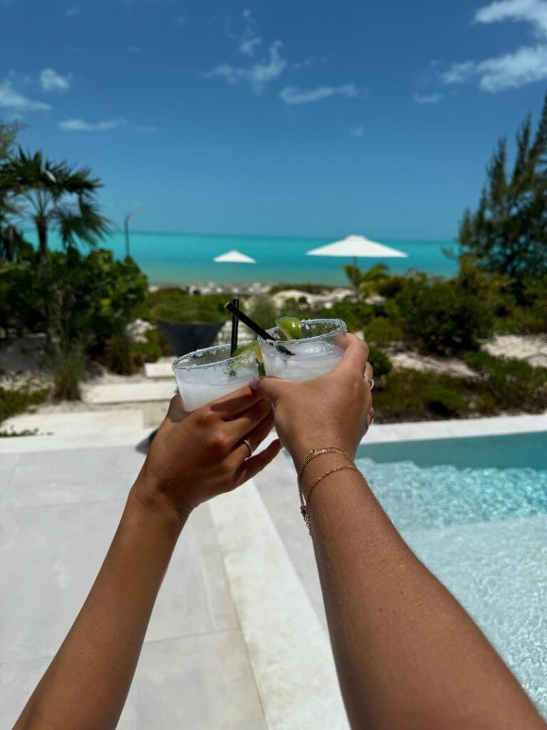Toasting cocktails by the ocean