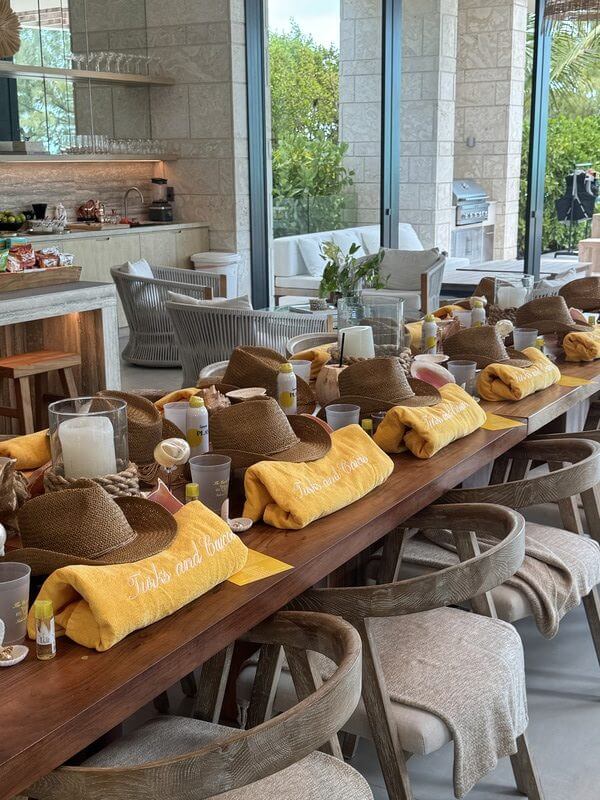 Table setup with yellow towels and hats