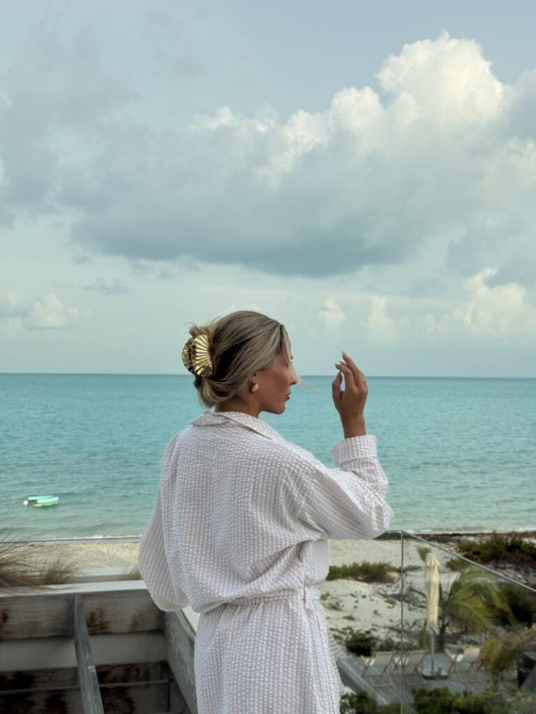 Jordan's friend in robe overlooking ocean at Turks and Caicos villa