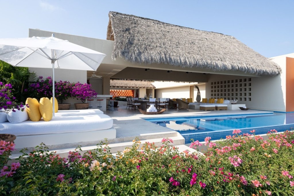 Casa Mandarina villa with ocean-view pool and tropical flowers during Events in Punta Mita 2025.