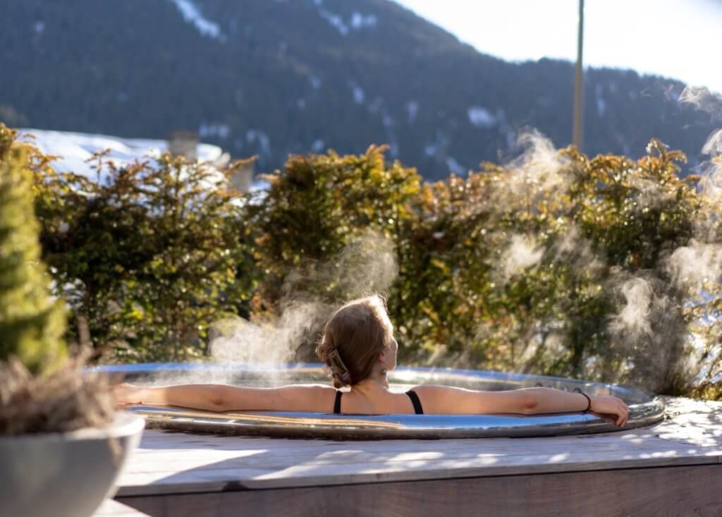 Outdoor spa at No. 14 Verbier, framed by snow-capped mountains and serene alpine light.