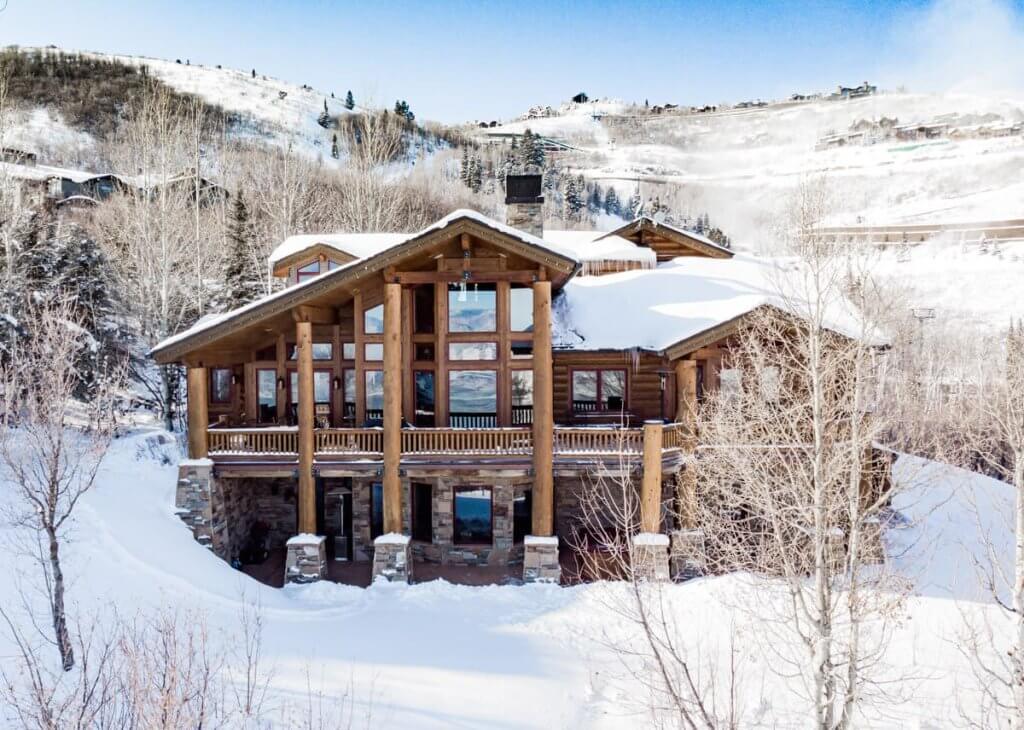 Mountain Glade chalet in Park City with snowy slopes, timber design, and panoramic mountain views.