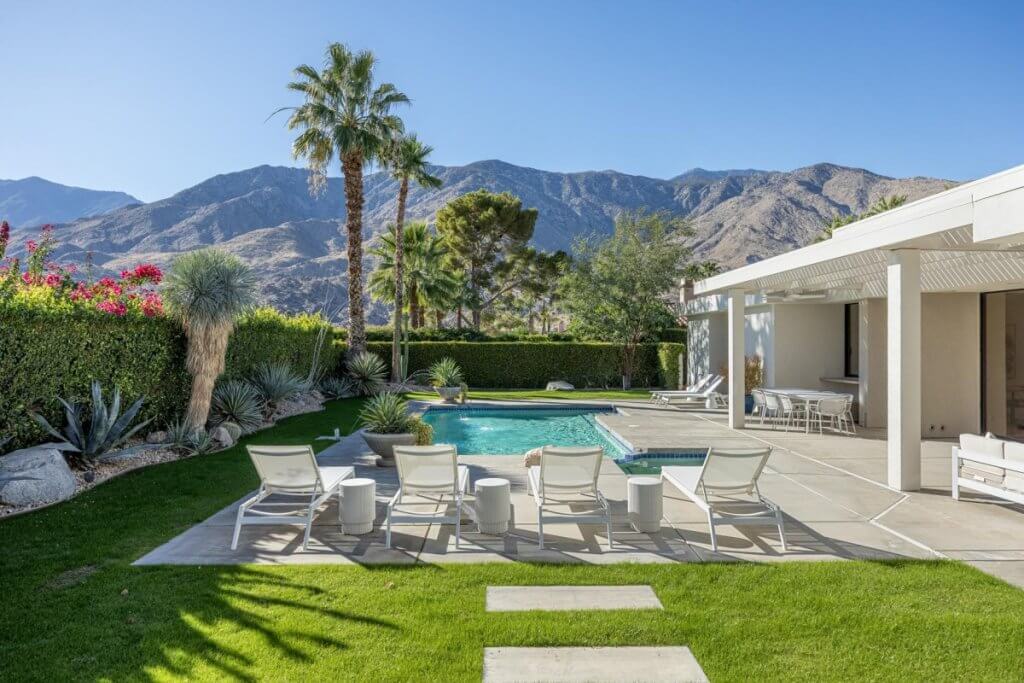 Villa Contemporary Dreams in Palm Springs with a sleek pool, modern loungers, and desert mountain views.