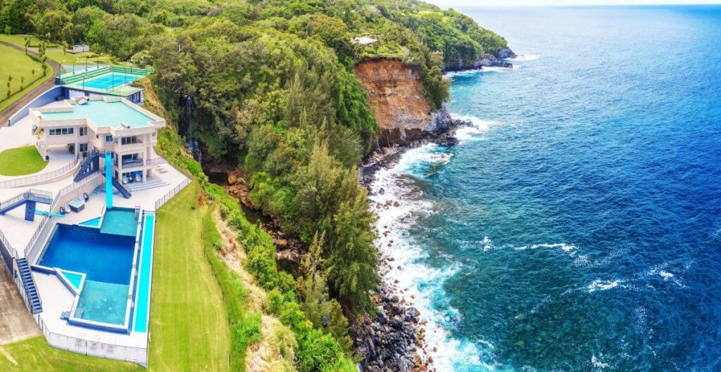 Waterfalling Estate in Kauai with ocean views, cliffside pool, and private waterfall