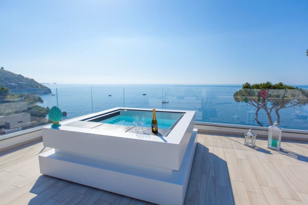 Rooftop hot tub at Neranyum villa on Amalfi Coast with ocean view, champagne, and elegant terrace decor.