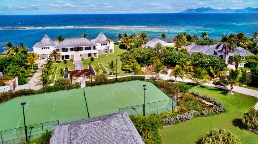 Villa Le Bleu on Anguilla with oceanfront grounds, a private tennis court, and elegant Caribbean architecture.