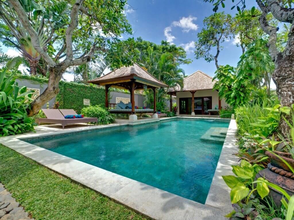 Kedidi Bali villa with a serene pool, shaded pavilion, and tropical gardens.