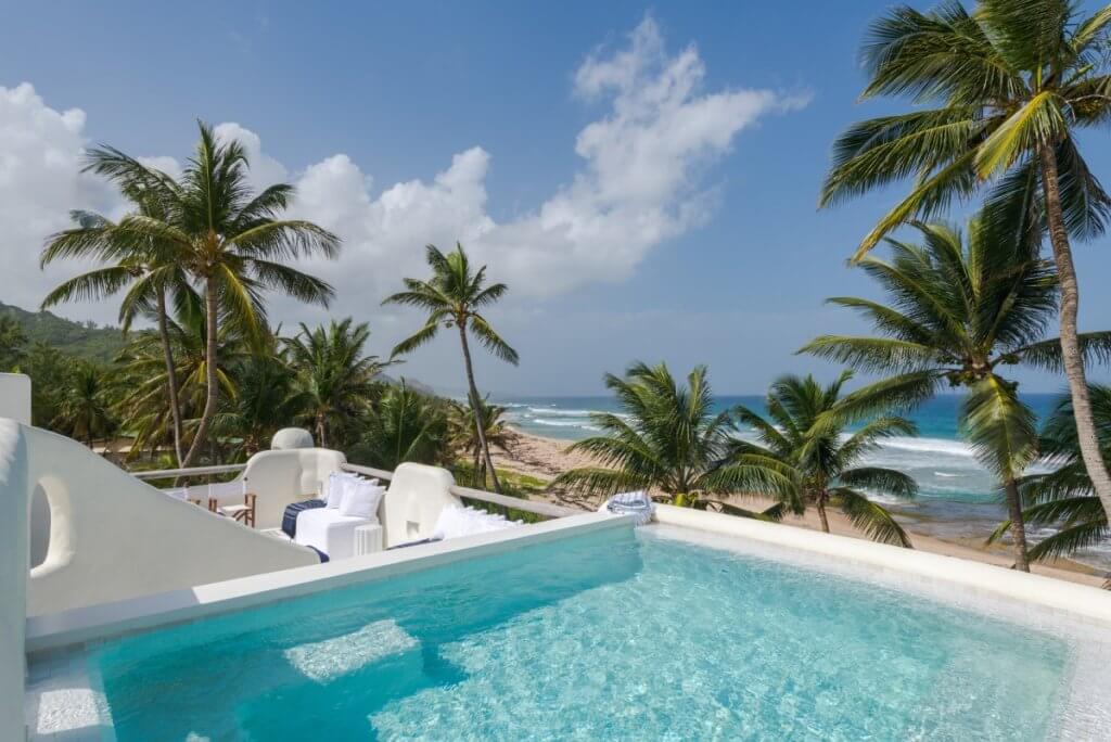 Rooftop pool at Pebble in Barbados overlooking palm-fringed shores, reflecting the charm of the Top 10 Honeymoon Destinations.