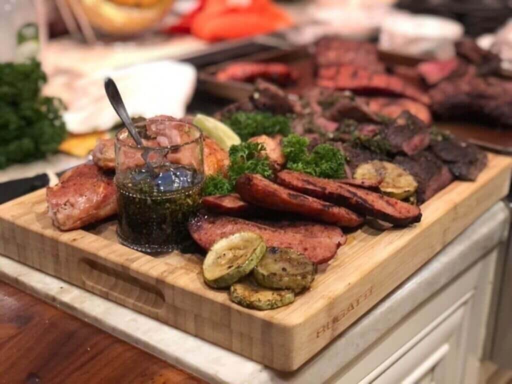 Villa Firenze showcases experiential luxury travel with a chef-prepared grilled feast featuring artisanal meats, herbs, and fresh ingredients.