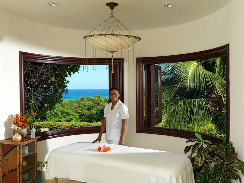 Villa Flower Hill showcases experiential luxury travel with a private spa room, massage table, and serene ocean and garden views.
