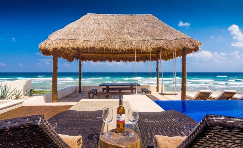 Villa Sofia in Tulum with oceanfront palapa lounge, infinity pool, and sunbeds, one of the Top 8 Luxury Destinations in March
