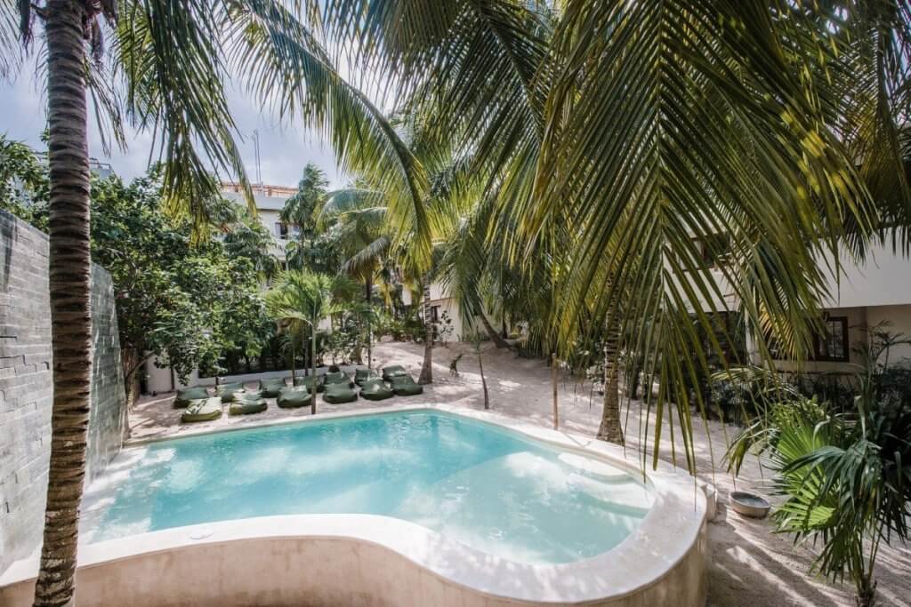 Zorba Tres Tulum villa with a sculpted pool and palm-shaded loungers, highlighted in the Top 10 Honeymoon Destinations.