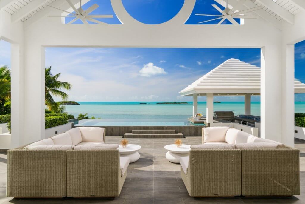 For villa image (focus on what is seen in the picture and its luxurious amenities):
Alt text: briefly describe what is in the picture and include the main keyword (under 125 characters) Caption: describe exactly what is shown in the picture, meaning the amenities, surroundings etc (under 160 characters) The copy must not be generic. The villa name is: Twin Palms TCI, Turks & Caicos alt text mora da sadrzi kljucne reci top 5 luxury destinations in februaryv