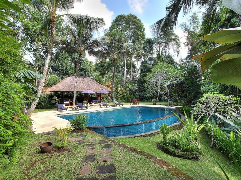 Alamanda Bali is luxury top 5 destination in February with lagoon pool under palms, thatched pavilion, and sculpted garden
