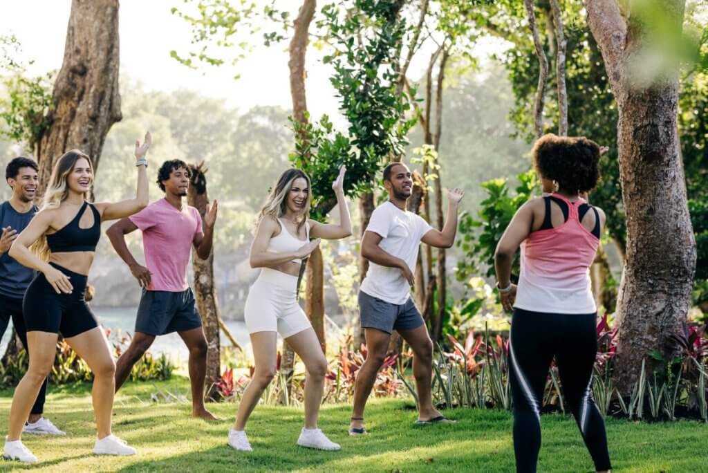 Guests enjoy a guided outdoor workout in Ani Villa’s tropical garden, showcasing concierge-villa-services in action.